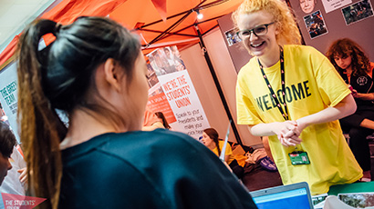 Student being welcomed by staff member at UWE Bristol Freshers' Fair