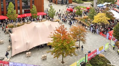 Aerial view of Freshers Fair outside the Engineering Building with brightly coloured banners and stalls.