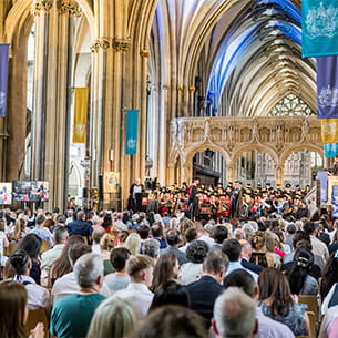 Crowd at Bristol Cathedral watching a graduation ceremony