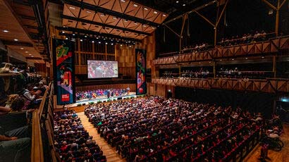 Wide angle shot of a full auditorium at the Graduation Ceremony at the Bristol Beacon.