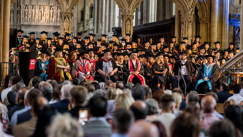 The crowd seated in Bristol Cathedral watching a graduation ceremony