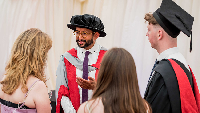 Graduates talking amongst themselves in the marquee