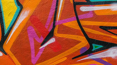 A close up of some colourful orange graffiti.