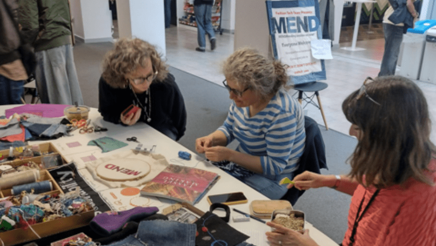 A group of women mending and modifying clothes at Bower Ashton campus.