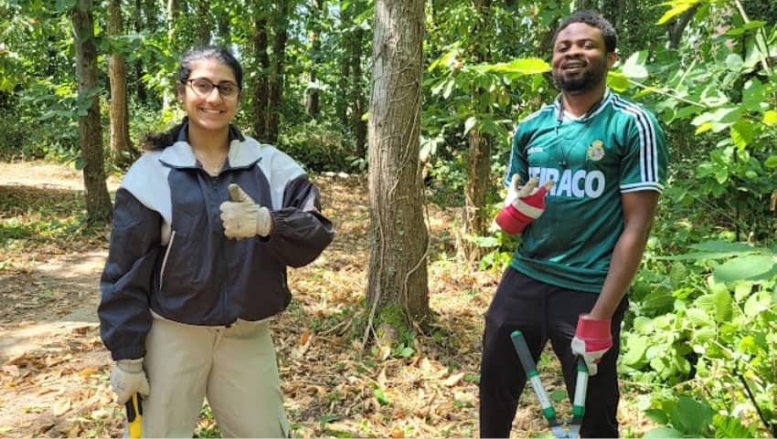 Two students taking part in a social gardening project.