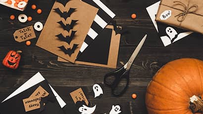 A selection of crafting materials in black, white and orange along with a pumpkin.
