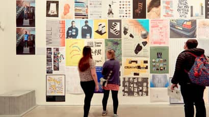 People look at the work at a degree show