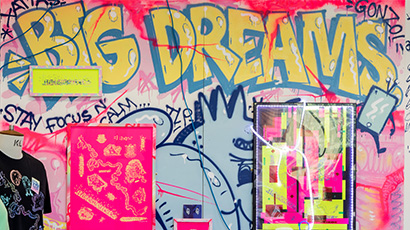 Graffiti style mural in pink, grey and yellow with words 'big dreams'
