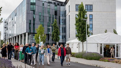A group of people being led on a tour around Frenchay campus.
