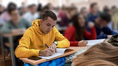 Student taking notes in lecture