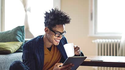 Smiling man viewing an iPad 