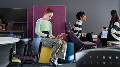 Student with a laptop in a UWE café bar