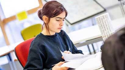Female student looking down at paperwork.