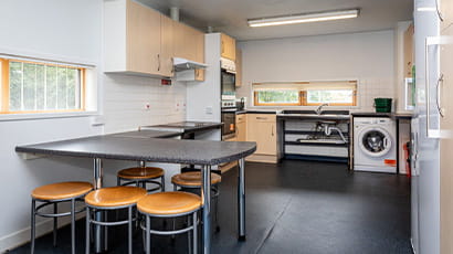 Example of a kitchen in an accessible student flat with a sink and hob that have wheelchair access.