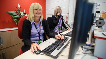 Two staff members at accommodation help desk