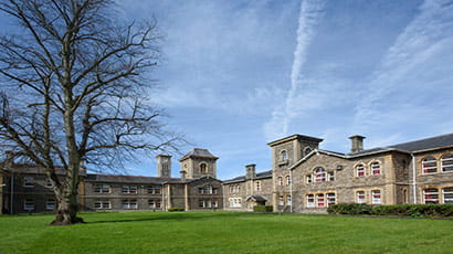 Glenside building from the outside, with grass and tree in the foreground. 