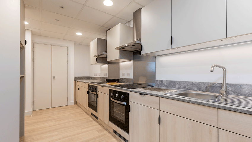 Kitchen workspace including sinks and ovens.