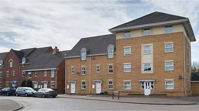 A row of flats on a quiet street.
