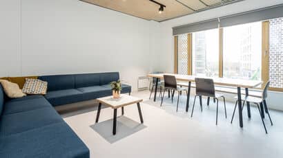 A typical communal area in Purdown View with a large blue sofa and seating area.