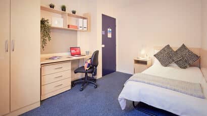 Example of a room in the Student Village with single bed and study space.