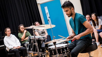 Student playing the drums at the Centre for Music.