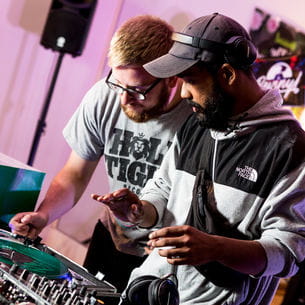 Two students giving a DJ performance.