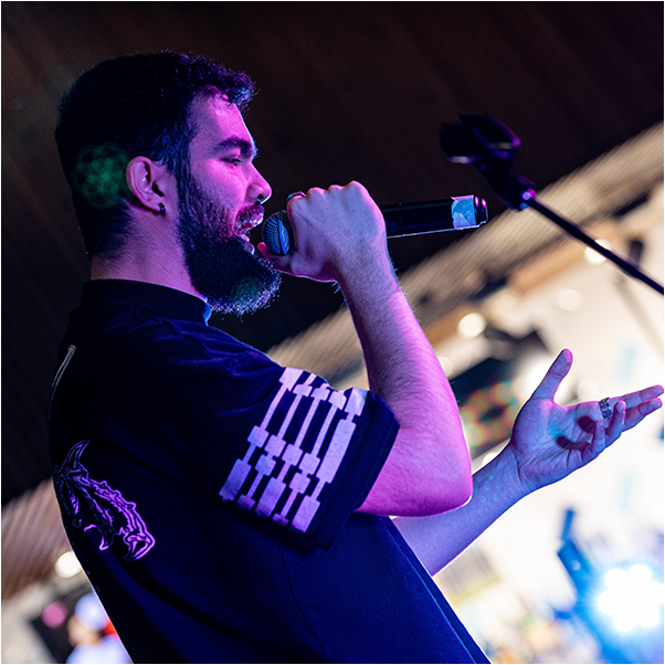 bearded man singing into microphone