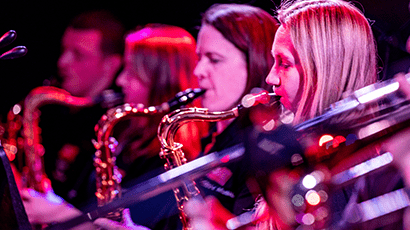 image of 4 young people playing saxophone