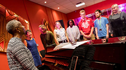 Group of students and staff having a music lesson