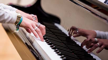 Hands at a piano keyboard