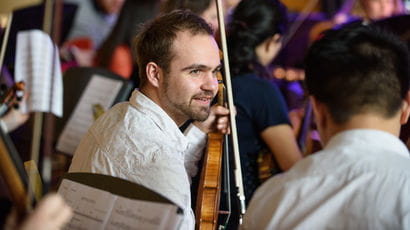 Male violinst in the Orchestra