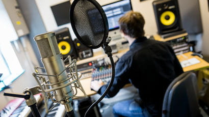 Musician recording music in a studio