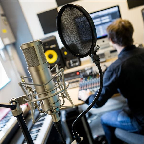 Musician recording music in a studio