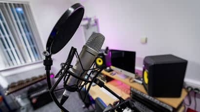 A close up of a microphone in a recording studio.