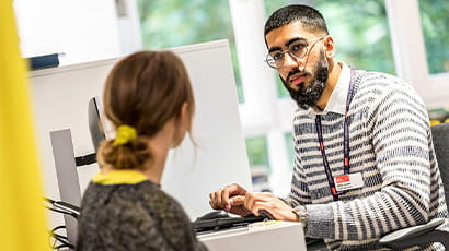 Student Optometrist talking to a patient during a consultation.