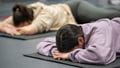 Two students lying on mats during a Relax and Recharge session.