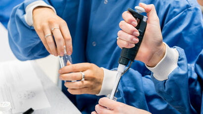 Science students using precise scientific equipment.