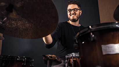 Music tutor 'AJ' playing the drums