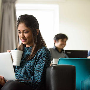 Student reading a tablet in student accommodation