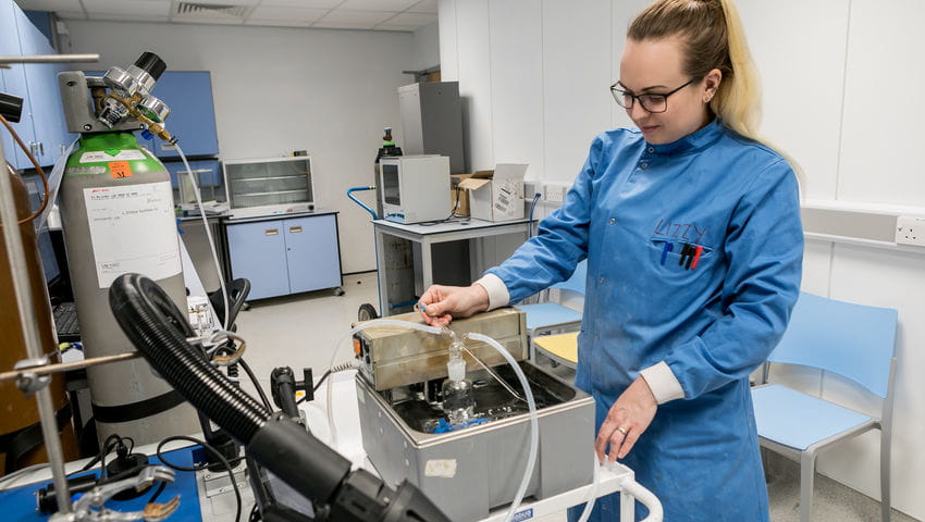 Bioscientist using big piece of equipment