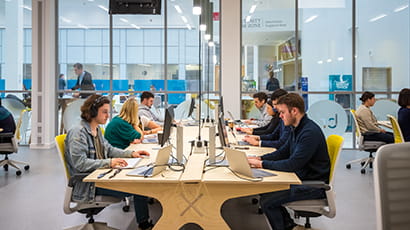 Graduates working on their computers in Launch Space.