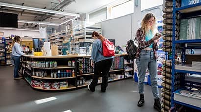 The art shop at Bower Ashton, a group of students are browsing the art supplies.