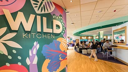 Wild Kitchen entrance with colourful mural on the wall.