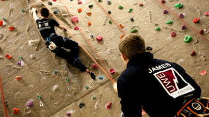 Two people on the climbing wall at the UWE sports centre