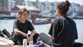 Students sitting by the harbourside