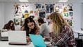 Couple of students looking at laptops