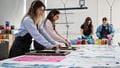 A couple of students screenprinting