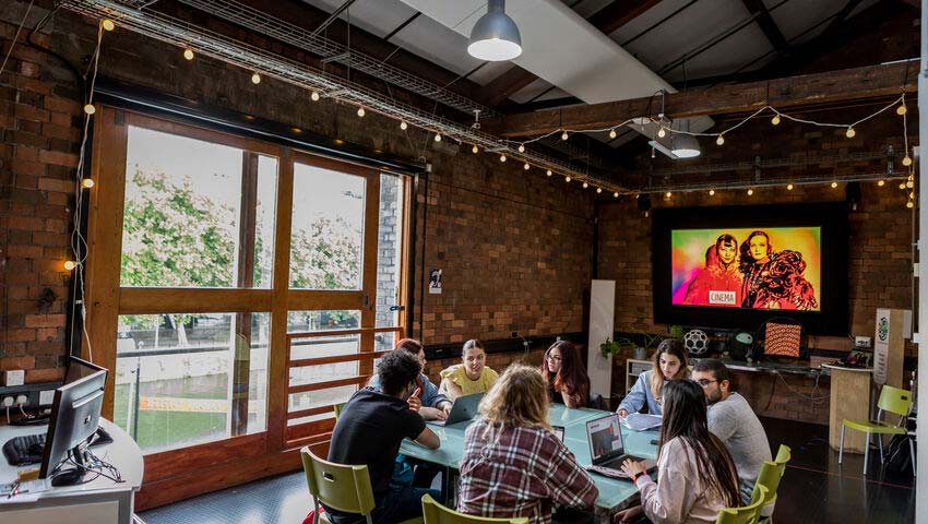 Student sat around a table at the Watershed