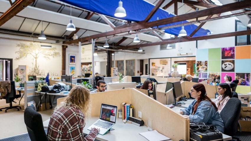 People in a workspace at the Watershed