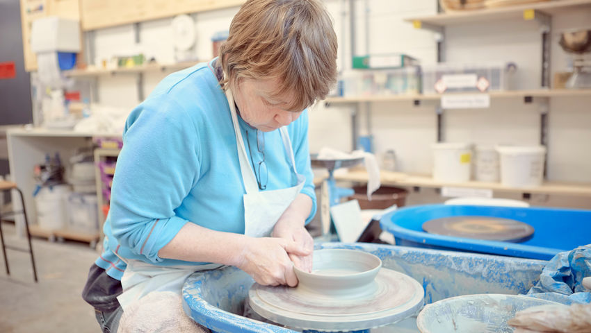 A lady making pottery